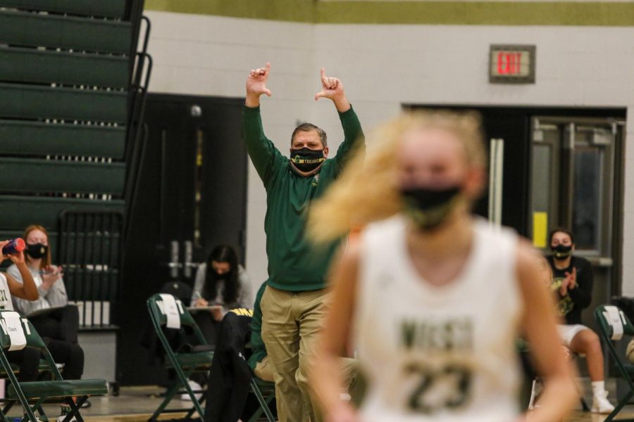 Head coach BJ Mayer calls out a play from the sideline against City High on Dec. 18.