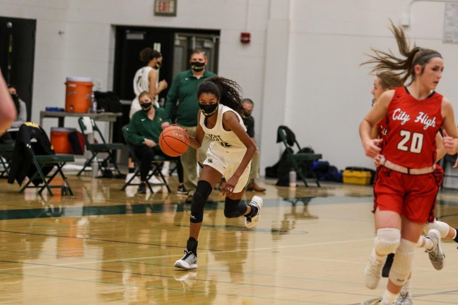 Meena Tate '23 pushes the ball up the floor on a fast-brake against City High on Dec. 18. 