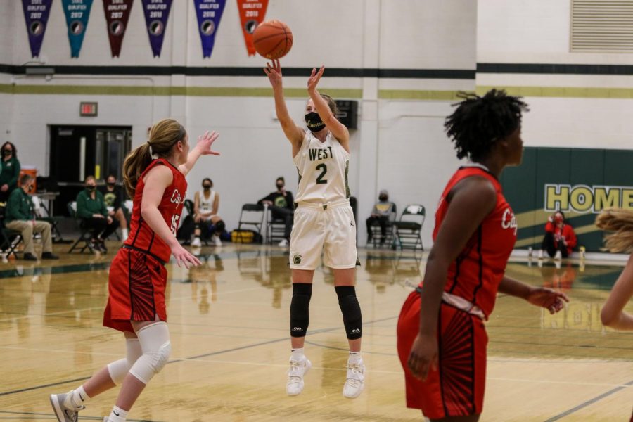 Lucy Wolf '24 takes a shot from beyond the arch against City High on Dec. 18.