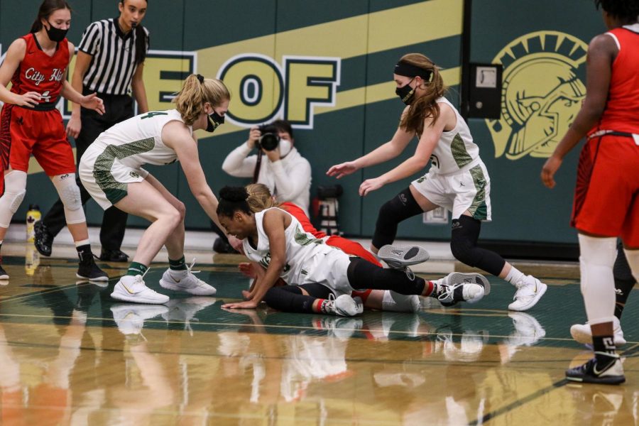 Emma Ingersoll-Weng '22 and Jenna Saunders '21 fight for a loose ball against City High on Dec. 18.