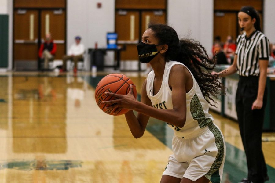 Meena Tate '23 looks to shoot a three against City High on Dec. 18.