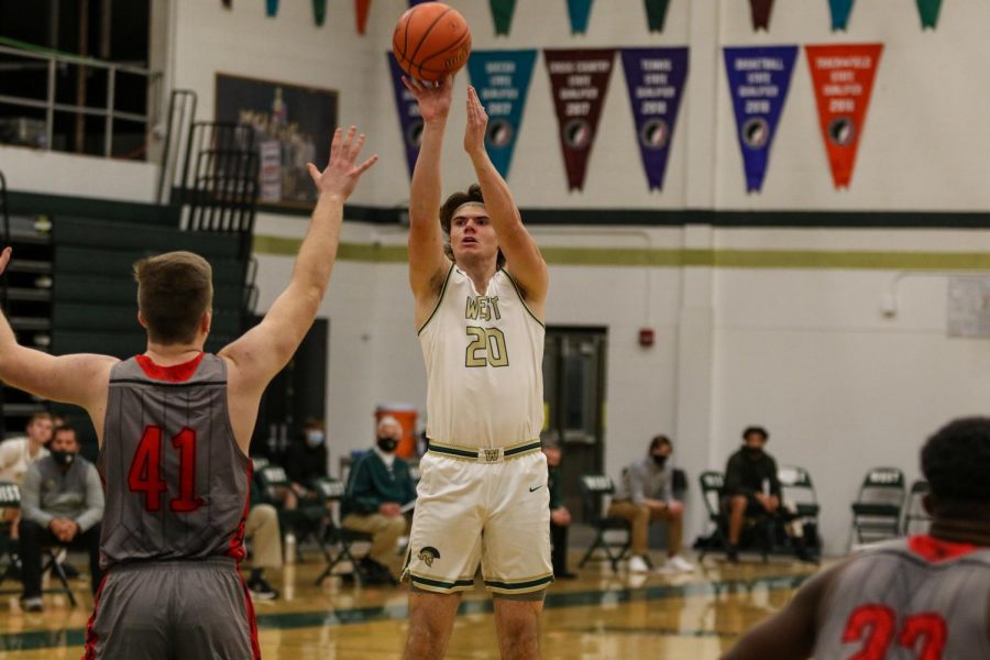 Pete Moe '22 shoots from beyond the arc against City High on Dec. 18.