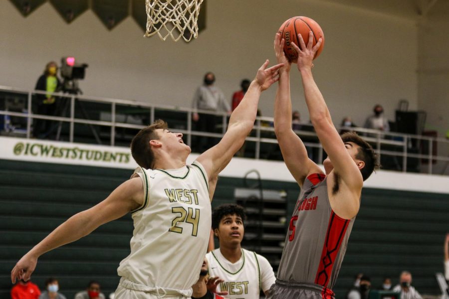 Grahm Goering '21 reaches for a rebound against City High on Dec. 18.