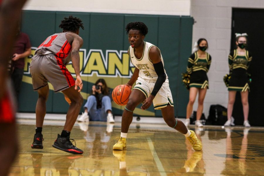 Christian Barnes '22 brings the ball up the floor against City High on Dec. 18.