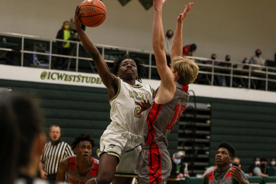 Christian Barnes fights through some contact to make a layup against City High on Dec. 18.