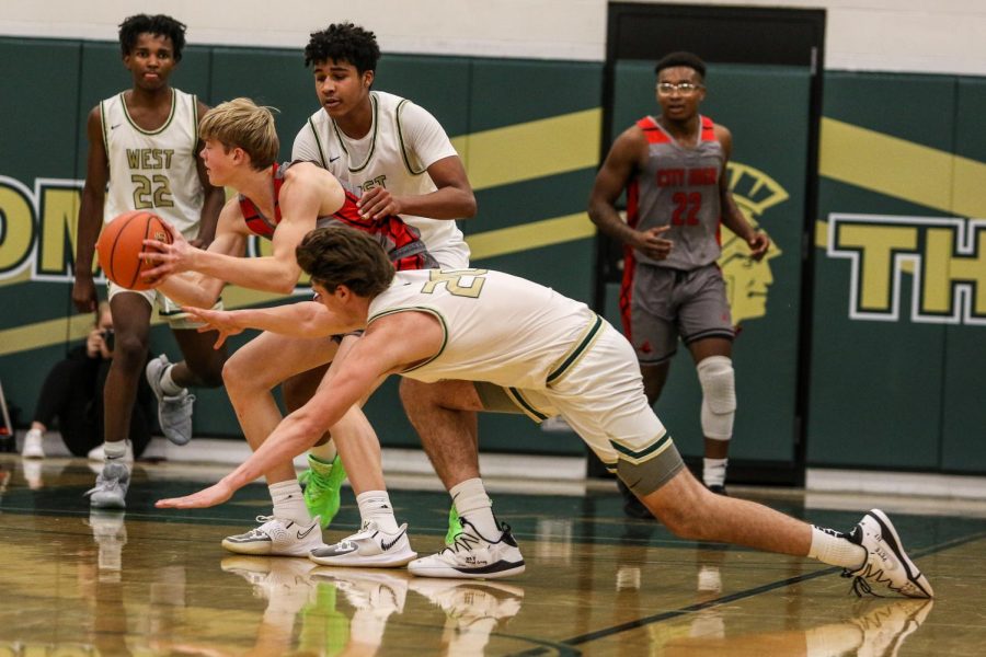 Pete Moe '22 reaches for a steal against City High on Dec. 18.