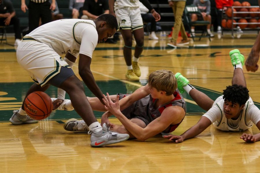 Mikey Crutcher '21 fights for a loose ball against City High on Dec. 18.