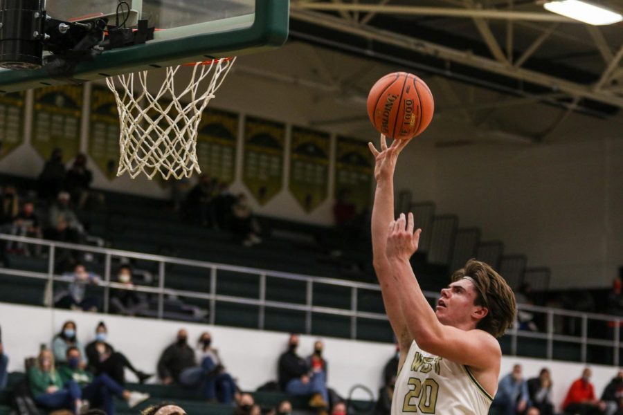 Pete Moe '22 knocks down a floater against City High on Dec. 18.