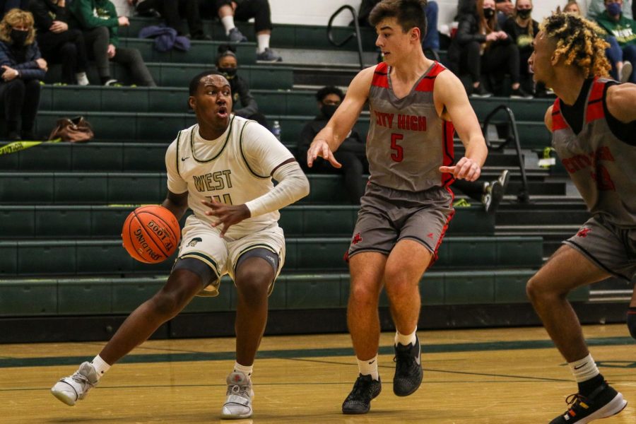 Mikey Crutcher '21 drives the baseline against City High on Dec. 18.