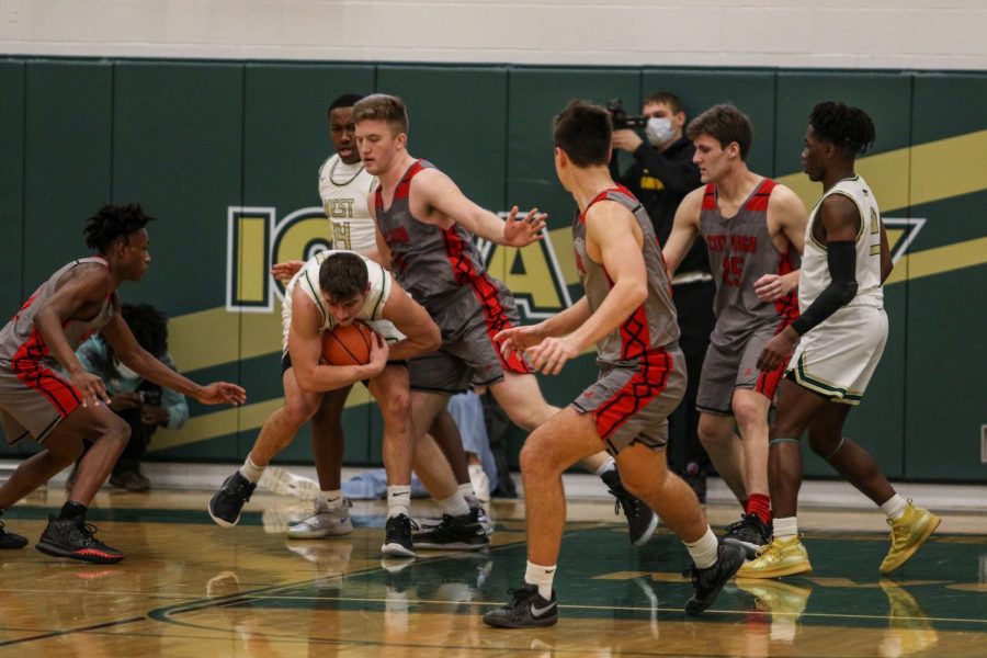 Grahm Goering '21 secures a big rebound with seconds left in regulation against City High on Dec. 18.