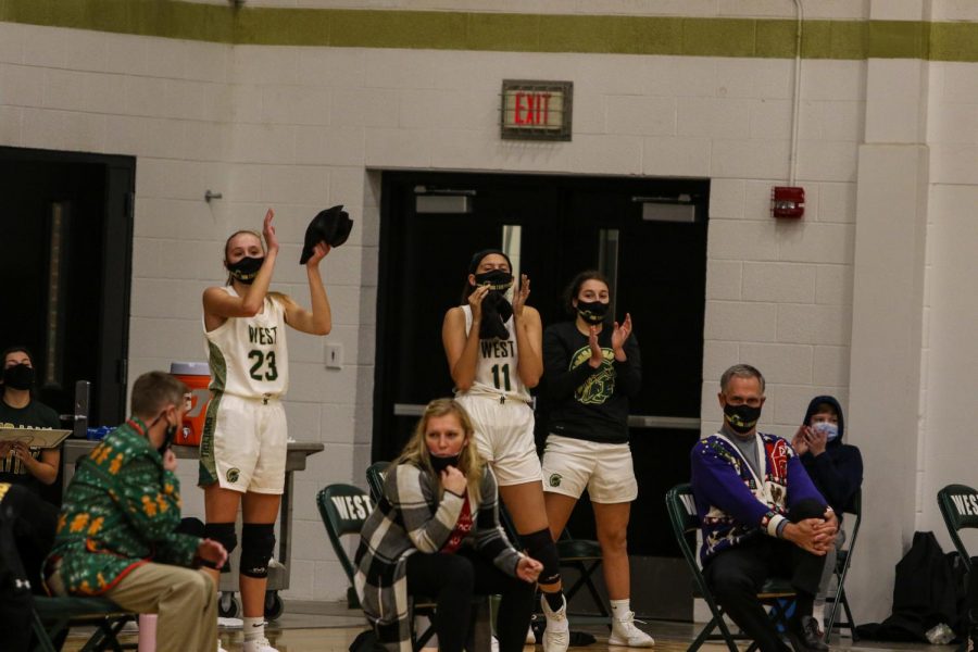 The socially distant bench celebrates a Trojan three against Linn-Mar on Dec. 22. 