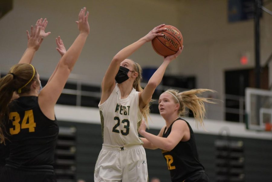 Audrey Koch ‘21 swings the ball around Southeast Polk defense for two points Jan. 2.