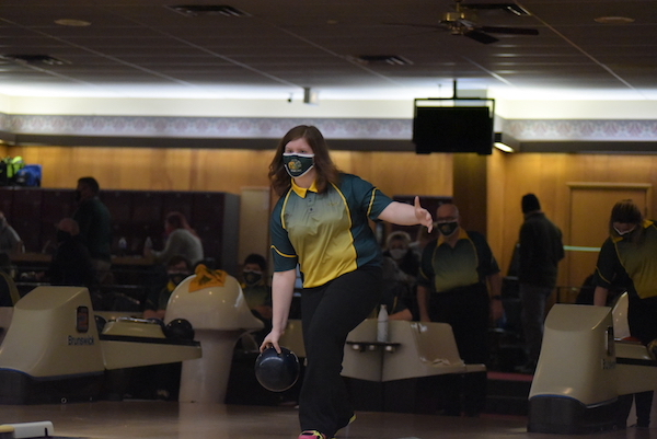 Kayla Schindler 23 keeps an eye on the pins while stepping forward to start her bowl Jan. 7. Schindler led the girls team with a score of 341 in two games. 