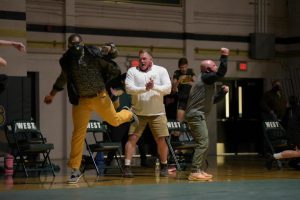 After a hard fought battle by Junior Brett Pelfrey in overtime, coaches cheer with excitement for the victory against Hempstead on Jan. 21.