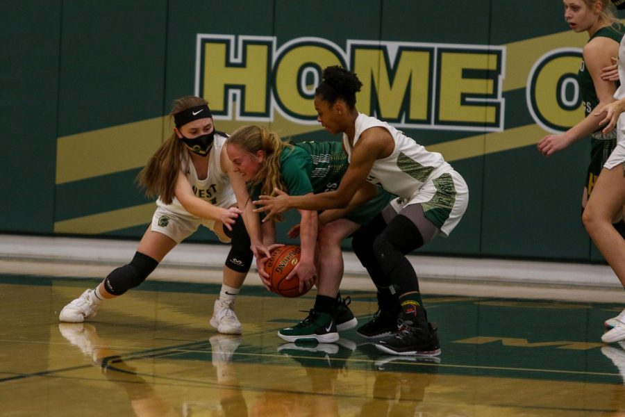 Jenna Saunders '21 and Emma Ingersoll-Weng '22 fight for a loose ball versus Dubuque Hempstead on Jan. 12.