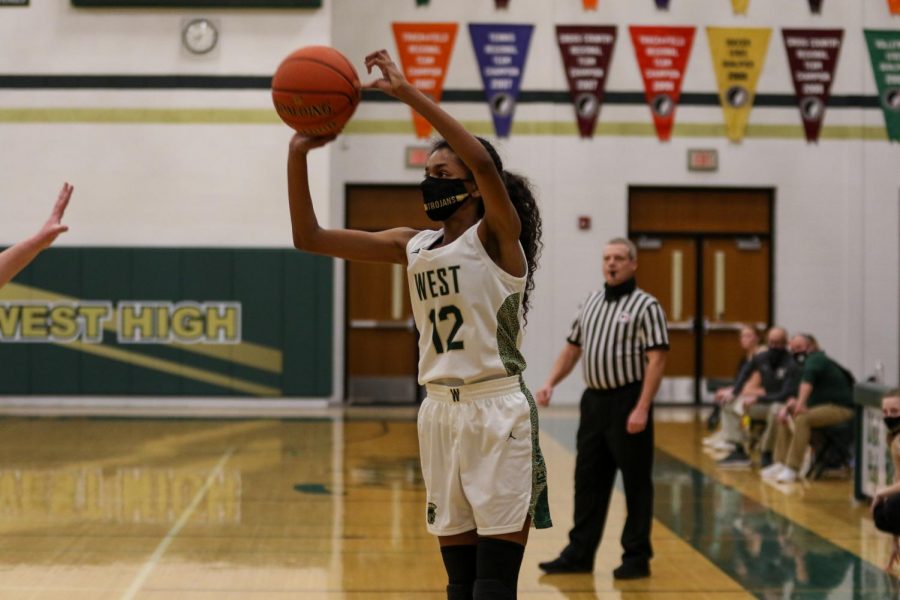 Meena Tate '23 knocks down a three-pointer versus Dubuque Hempstead on Jan. 12.