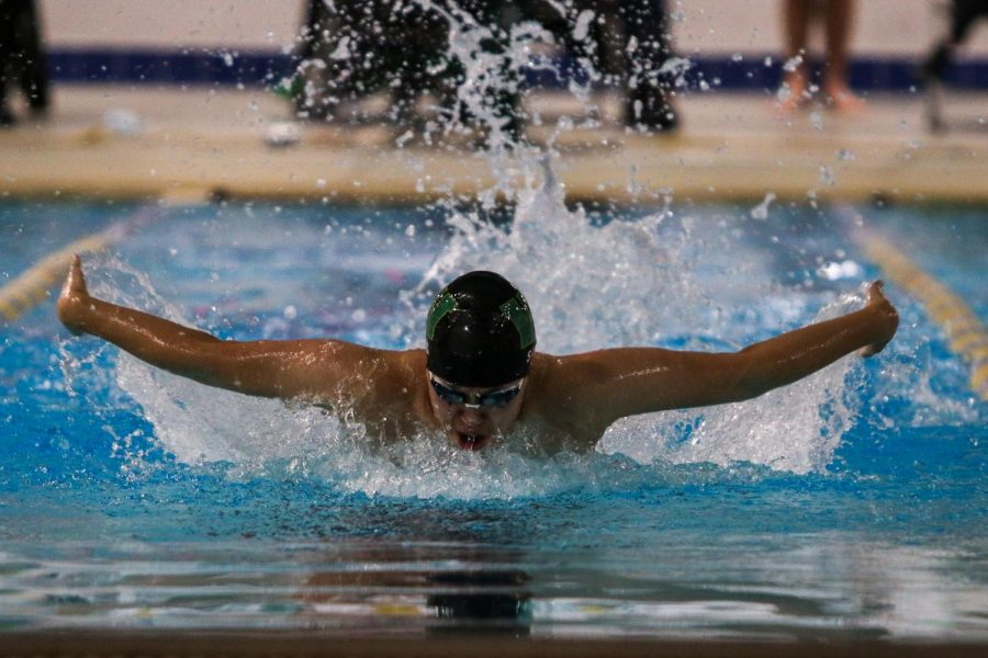 Nik Sung '22 swims in the 100 butterfly during a dual meet against Cedar Rapids Washington on Jan. 14.