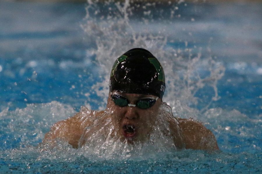 Nik Sung '22 takes a breath while swimming in the 100 butterfly during a dual meet against Cedar Rapids Washington on Jan. 14.