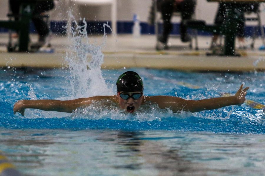 Andy Luo 22 swims in the 100 butterfly during a dual meet against Cedar Rapids Washington on Jan. 14.