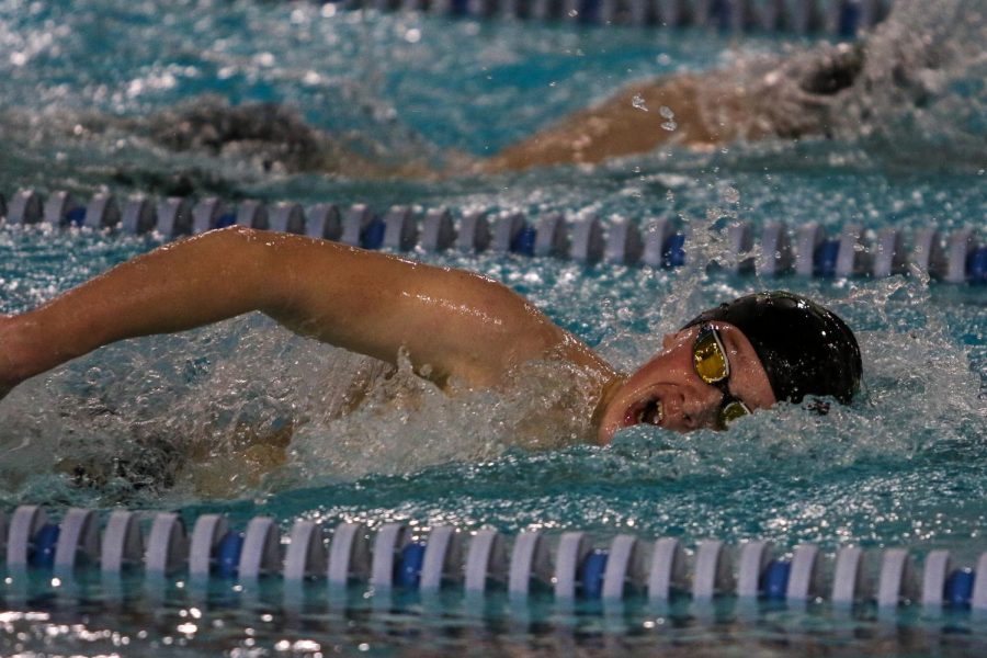 Luke Swanson '23 takes a breath while swimming in the 500 freestyle during a dual meet against Cedar Rapids Washington on Jan. 14.