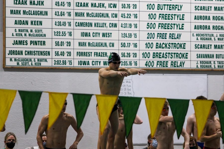 Luke Nichols '21 prepares to swim his leg of the 400 free relay during a dual meet against Cedar Rapids Washington on Jan. 14.