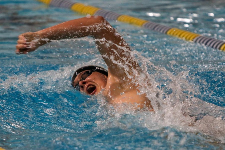 Nathan Deyak '21 takes a breath while swimming in the 400 free relay during a dual meet against Cedar Rapids Washington on Jan. 14.