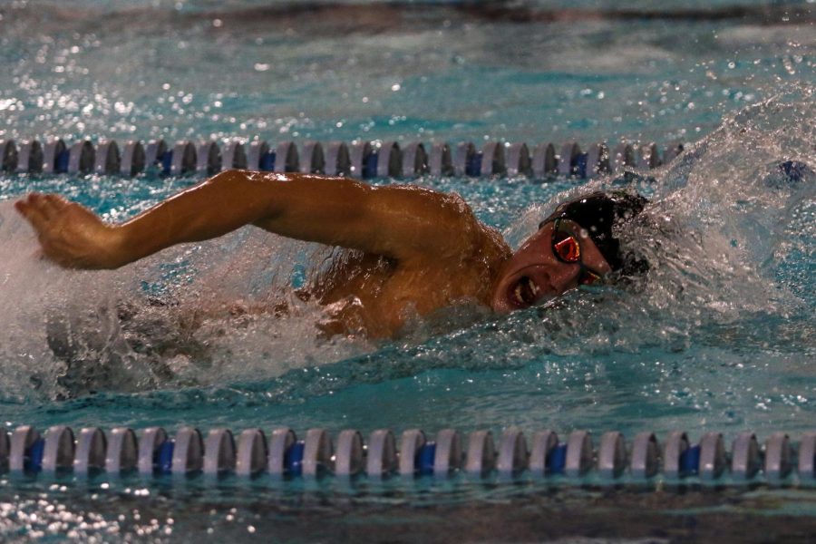 Holden Carter '24 swims in the 100 freestyle during a dual meet against Cedar Rapids Washington on Jan. 14.