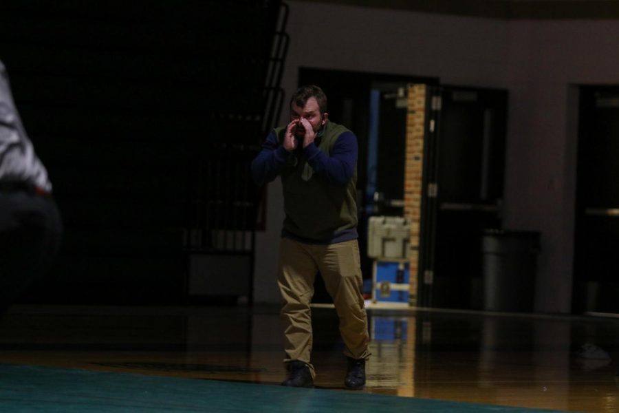 Head coach Nate Moore yells from the edge of the mat against Hempstead on Jan. 21.