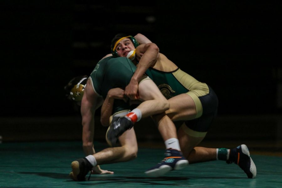 Hunter Garvin '22 takes down Mustang Cole Rettenmaier on Jan. 21.