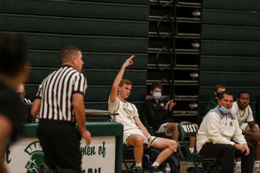 Andrew Tauchen '21 celebrates a Pete Moe '22 three from the bench against Burlington on Jan. 2.