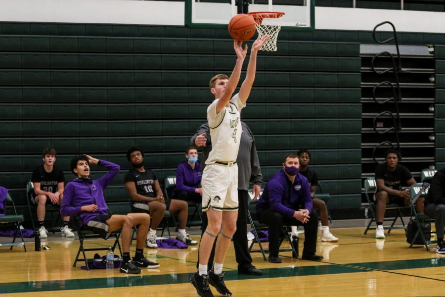 Andrew Tauchen '21 knocks down a corner three against Burlington on Jan. 2.