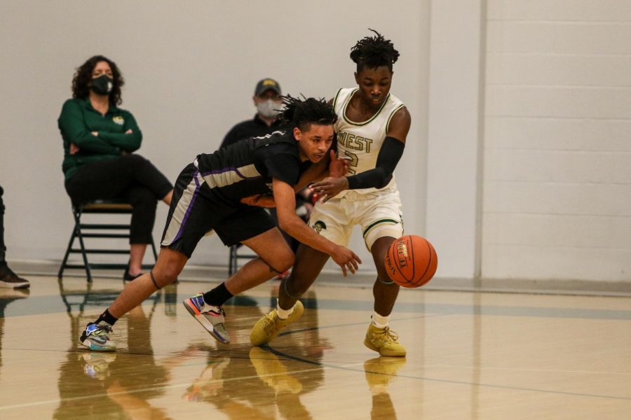 Christian Barnes '22 fights for a loose ball against Burlington on Jan. 2.