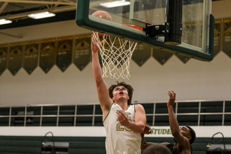 Pete Moe '22 tips in a bucket against Burlington on Jan. 2.