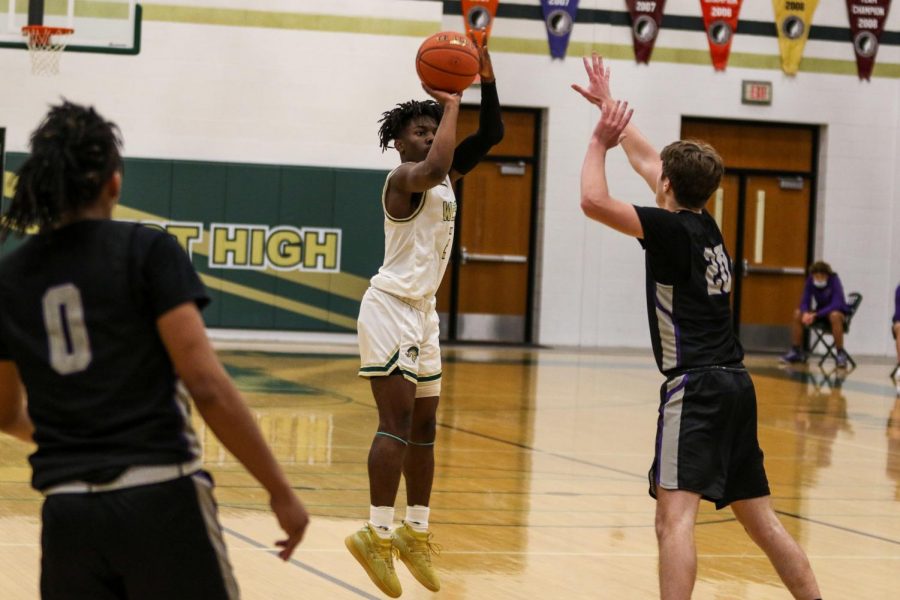 Christian Barnes '22 shoots a three from the top of the key against Burlington on Jan. 2.