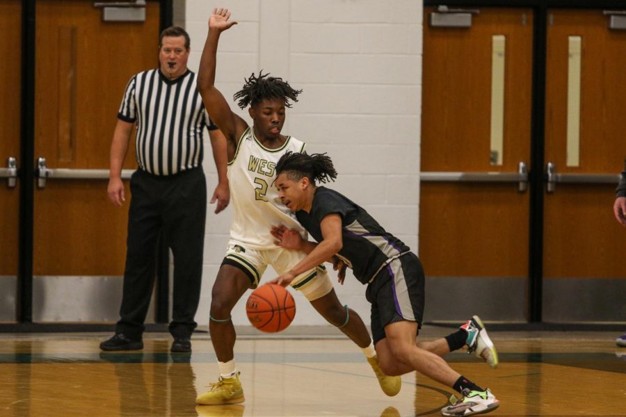 Christian Barnes '22 stops the drive against Burlington on Jan. 2.