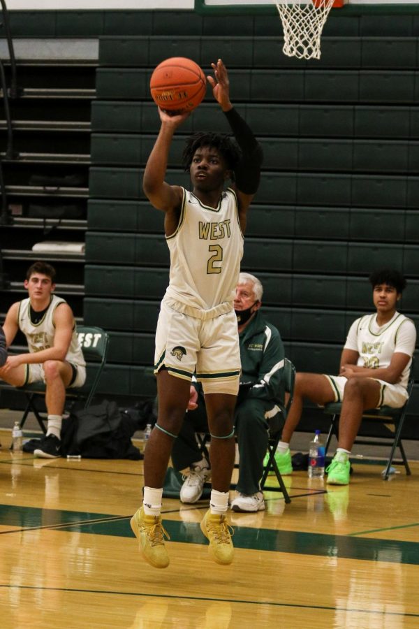 Christian Barnes '22 knocks down a corner three against Burlington on Jan. 2.