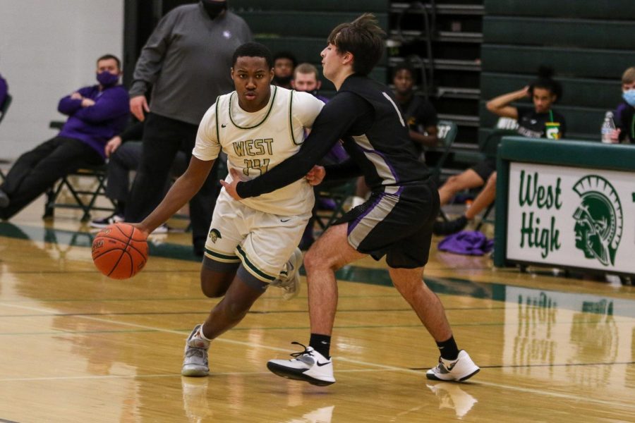 Mikey Brown '21 gets fouled while trying to drive against Burlington on Jan. 2.