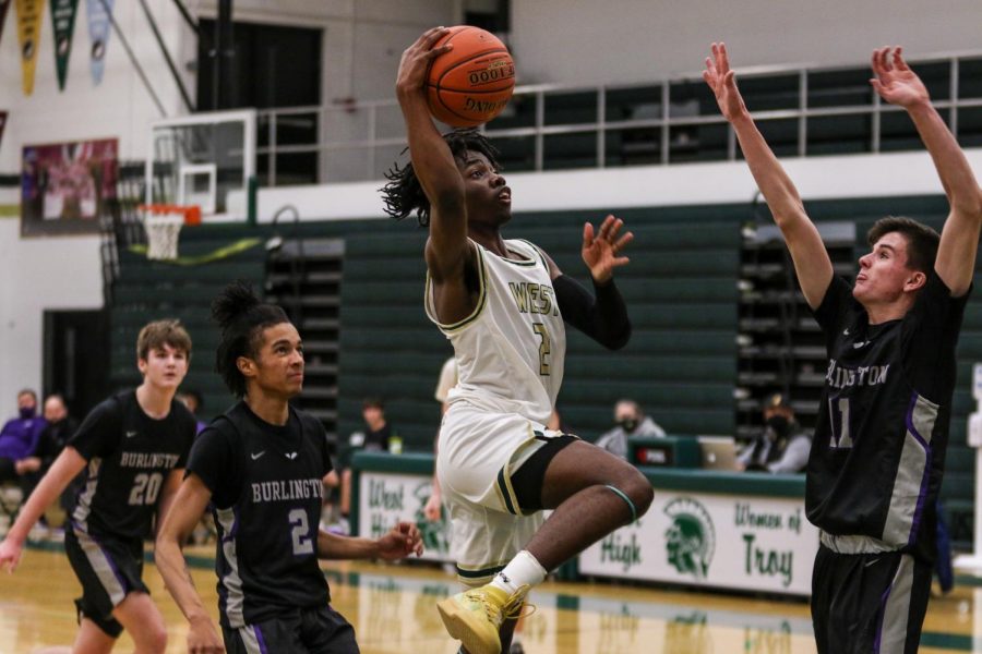 Christian Barnes '22 goes up for a layup against Burlington on Jan. 2.