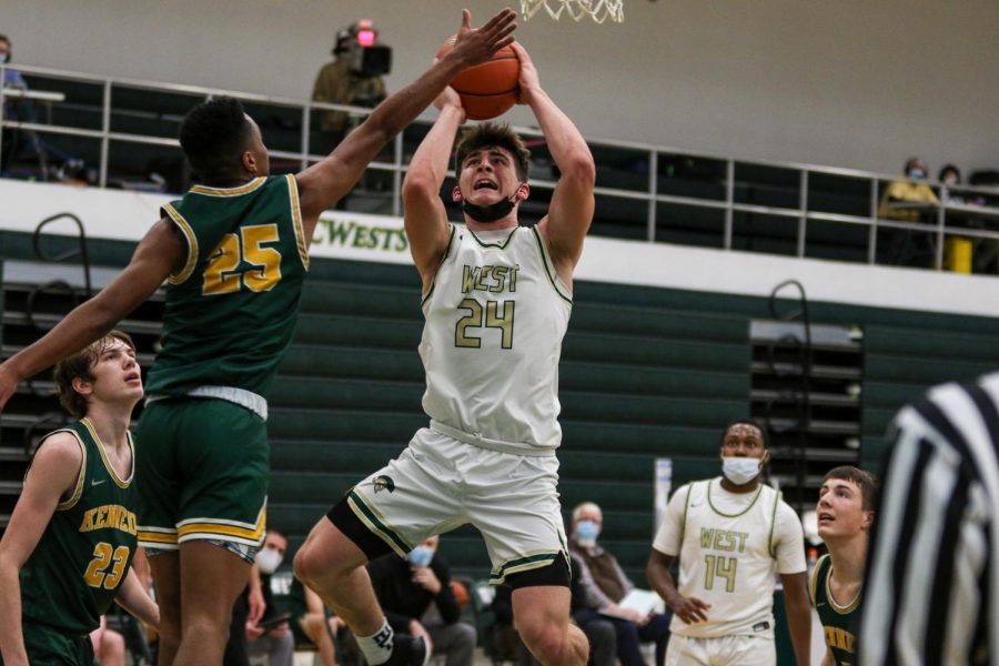 Grahm Goering '21 goes up for a contested layup against Kennedy on Feb. 11.