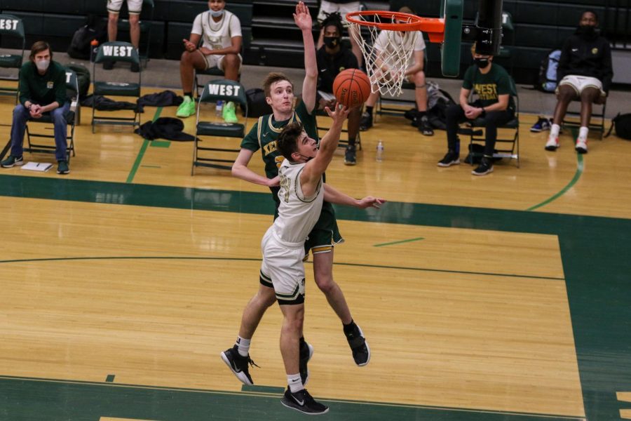 Grahm Goering '21 goes up for a layup in the fourth quarter against Kennedy on Feb. 11.