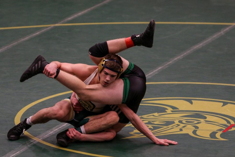 Graham Gambrall '21 gets in a position to score during the district wrestling meet on Feb. 13.