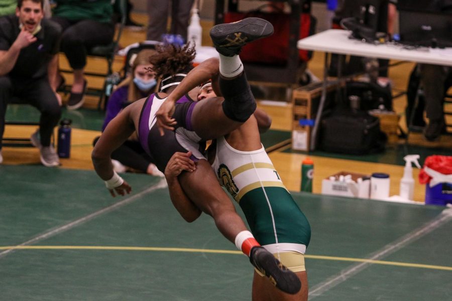 Mason Applegate '22 throws Liberty's Darius Willis Newell in the semifinals during the district wrestling meet on Feb. 13.