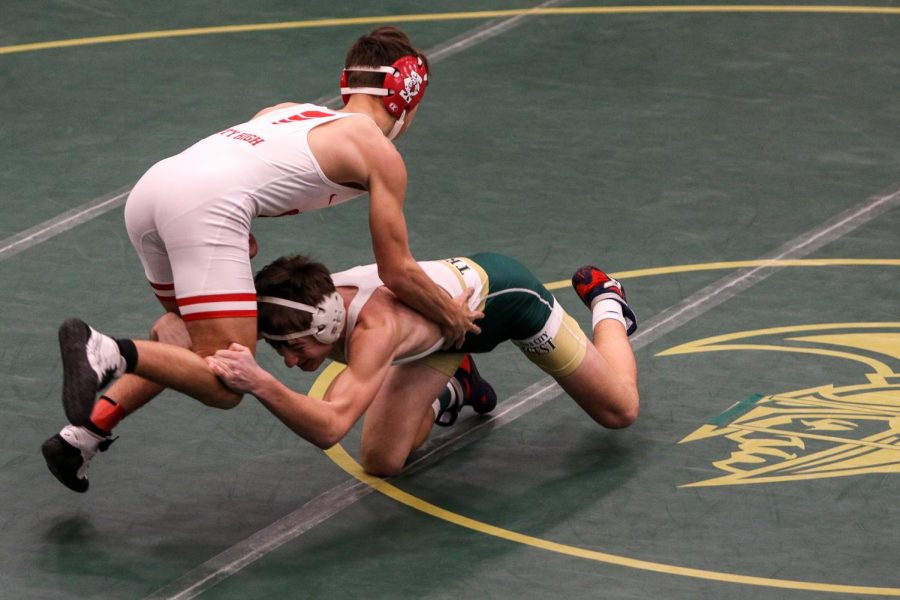 Parker McBride '22 shoots looking for a takedown during the district wrestling meet on Feb. 13.