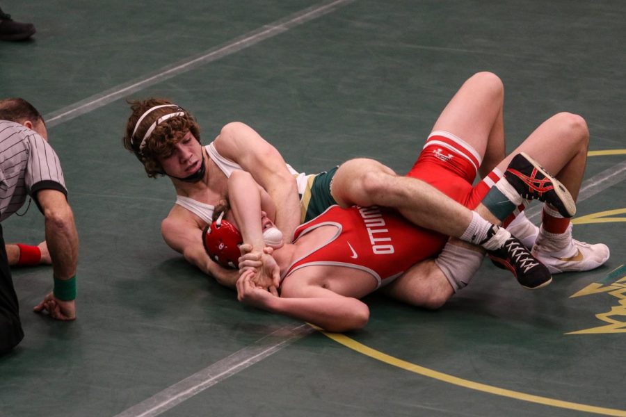 Kael Scranton '22 pins Ottumwa’s Braylon Griffiths ’24 during the district wrestling meet on Feb. 13.