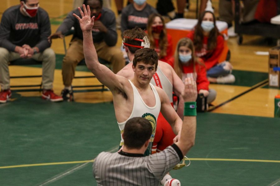 Ashton Barker '21 waves to the fans after defeating Ottumwa's Trevor Summers '22 during the district wrestling meet on Feb. 13.