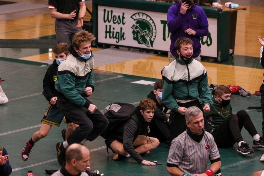 Juniors Grant O'Dell and Parker McBride celebrate a Mason Applegate '22 pin during the district wrestling meet on Feb. 13.