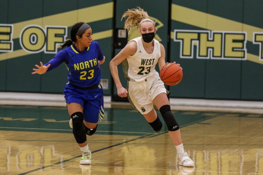 Audrey Koch '21 pushes the ball up the floor looking to score in transition against Davenport North during the substate final game on Feb. 23.