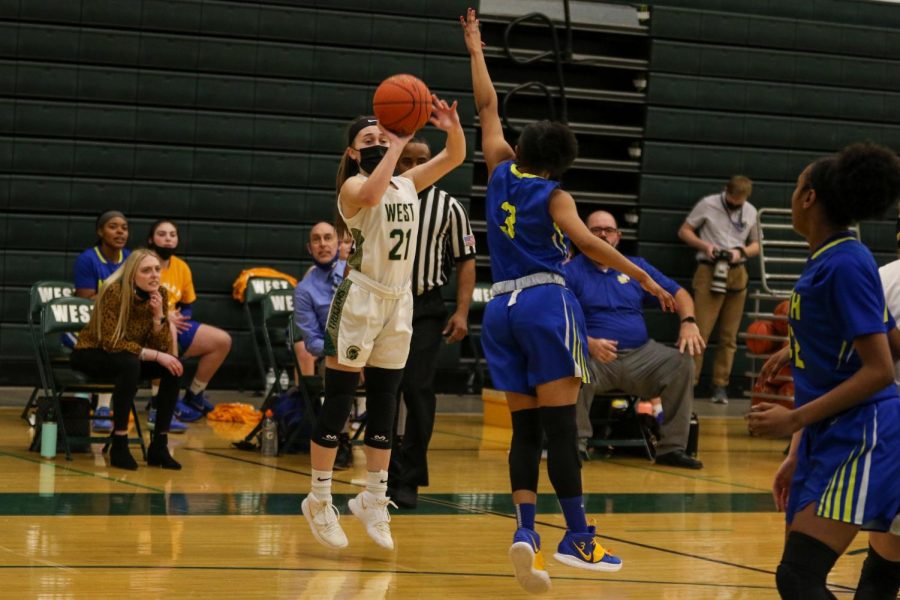 Jenna Saunders '21 shoots from beyond the arc against Davenport North during the substate final game on Feb. 23.