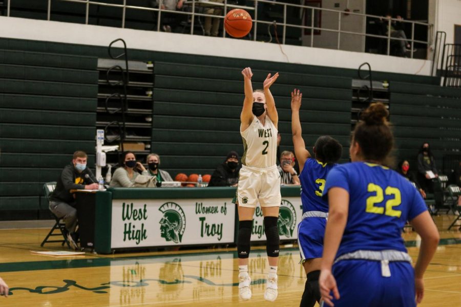 Lucy Wolf '24 banks in a three-pointer with seconds left in the half against Davenport North during the substate final game on Feb. 23.