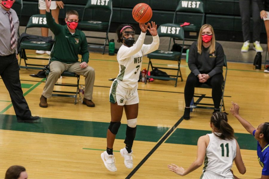 Matayia Tellis '21 knocks down a three against Davenport North during the substate final game on Feb. 23.